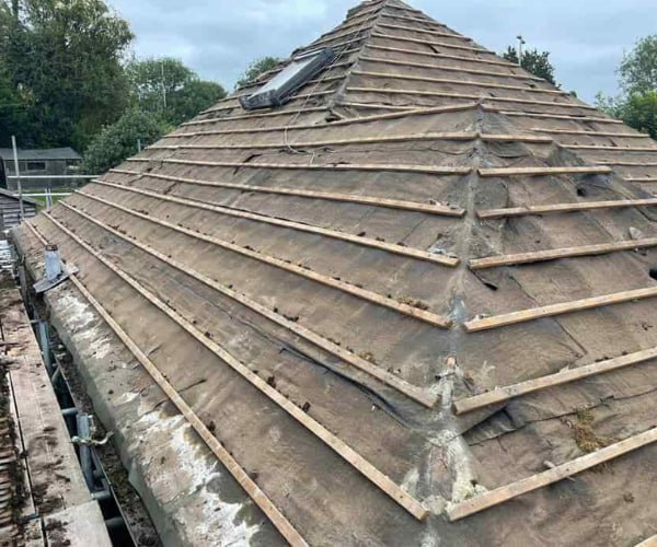 This is a photo of a hip roof that has been stripped back to the battens, and is awaiting a new roof covering to be installed. Works carried out by EA Roofing Daventry